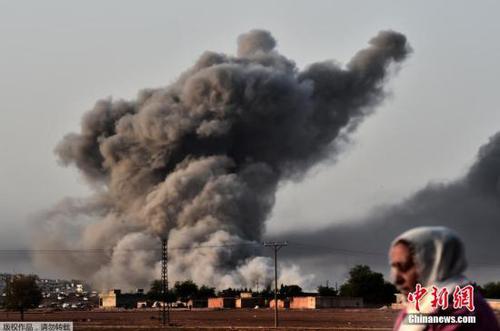 当地时间2014年10月13日，土耳其叙吕奇，美军及其盟友继续空袭科巴尼。叙库尔德难民远观城市上空战火浓烟滚滚，心中五味杂陈。