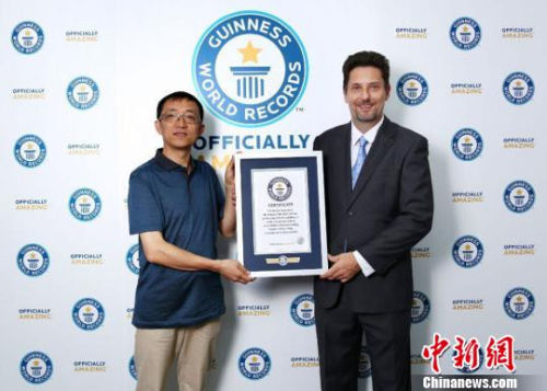 罗文向国家超级计算机无锡中心主任杨广文颁发吉尼斯世界纪录认证书。　徐颖洁 摄