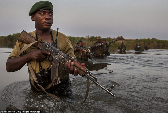 图为罗德里格-凯特姆博带领突击队员在刚果国家公园中越过河流进行反偷猎巡逻。