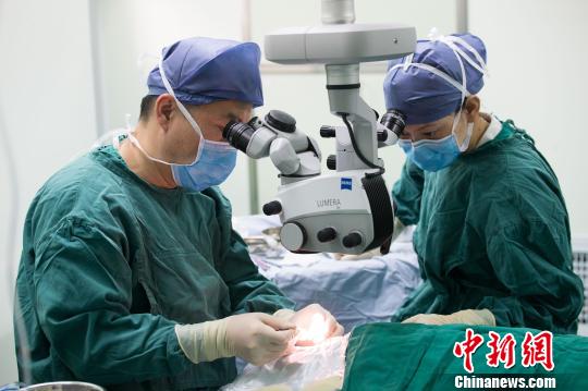 中国中医科学院眼科医院眼科主任医师、教授林涛(左)为留守老人做白内障手术。　李南轩 摄