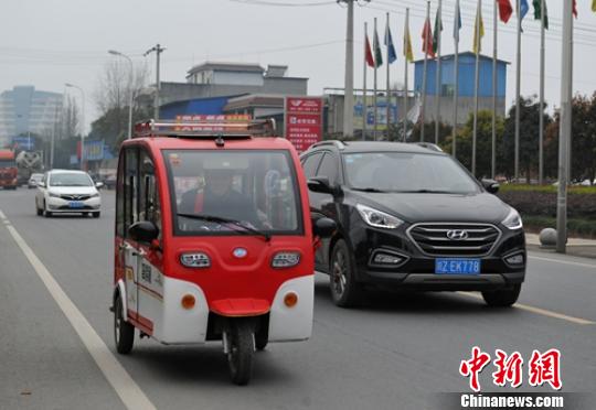 一位老者驾驶电动三轮车行驶在省道103线公路眉山段。　刘忠俊 摄