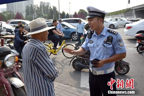 6月21日上午，北京交警敖翔正在处理交通违法行为。<a target='_blank' href='http://www.chinanews.com/' >中新网</a>记者 金硕 摄