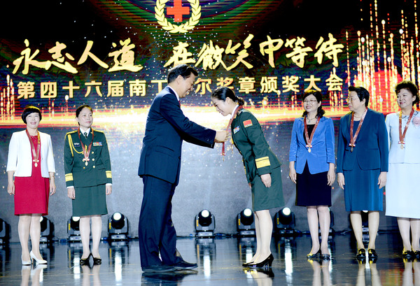 001  中共中央政治局委员、国家副主席、中国红十字会名誉会长李源潮为中国获奖者颁发南丁格尔奖奖章。