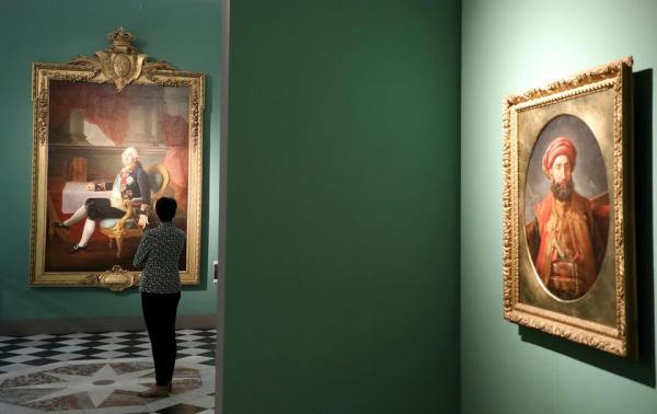 一位观众在凡尔赛举办的《凡尔赛的游客》临展中观赏一幅路易十六的肖像。