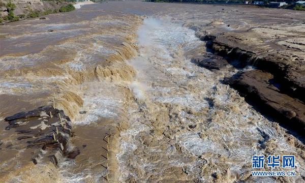这是10月11日无人机拍摄的壶口瀑布。 近日，位于晋陕大峡谷的黄河壶口瀑布水量持续增大，主副瀑布连成数百米的大瀑布，形成“水岸齐平”景观。