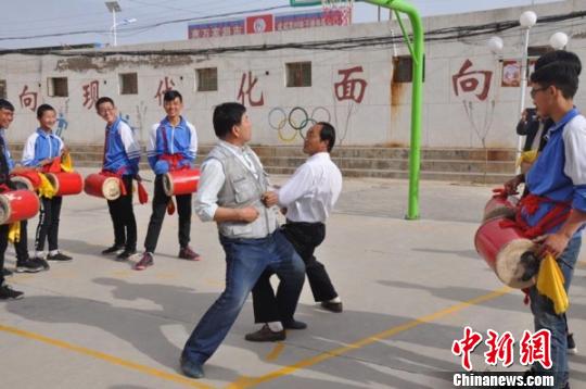 图为老师向学生示范凉州“攻鼓子”舞步和阵法。　钟欣 摄
