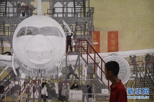 9月26日，“伟大历程 壮丽画卷——庆祝中华人民共和国成立70周年美术作品展”在北京中国美术馆开幕。这是观众在参观展出作品《中国制造走向世界—C919大飞机》。 新华社记者 鲁鹏 摄