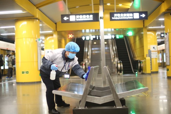 工作人员在给列车及车站各区域进行全面清洁消毒