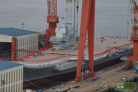 媒体:首艘国产航母船体插上红旗 围观军迷兴奋