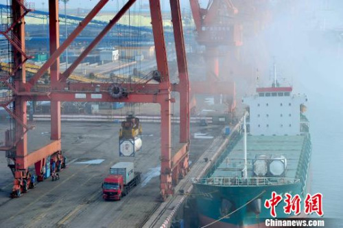 12月24日，广西防城港市北部湾港口集装箱码头上等待装运的集装箱货柜。胡雁 摄