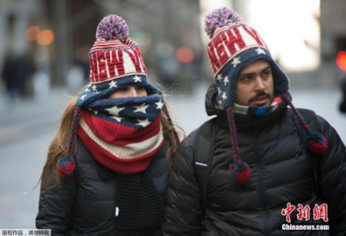 图为当地时间1月2日，纽约街头裹的严严实实的行人。