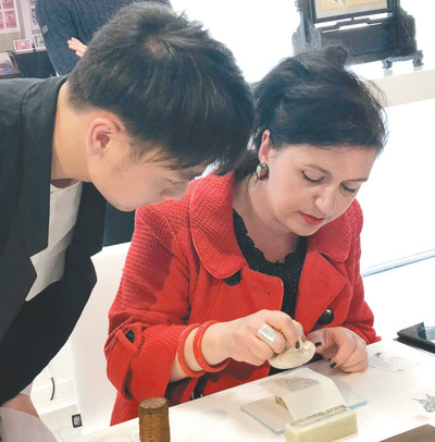 在伦敦手工艺周“技艺中国”展上，一位参观者在体验中国拓印工艺。本报记者 强 薇摄 
