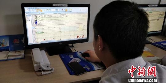 贵州省第二人民医院睡眠医学中心医务人员在对睡眠监测图判图 曾实 摄