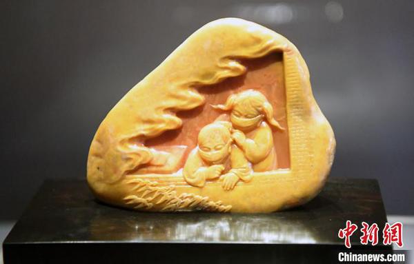 由中国工艺美术大师郑幼林创作的寿山石雕作品《人间有爱》。　记者刘可耕 摄