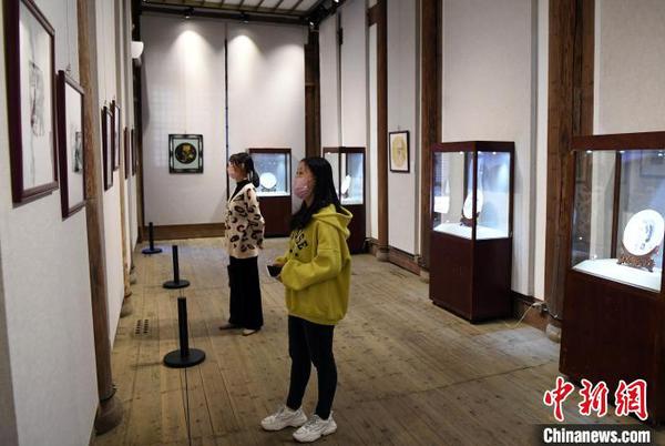 二名女青年观看该展览参展作品。　记者刘可耕 摄