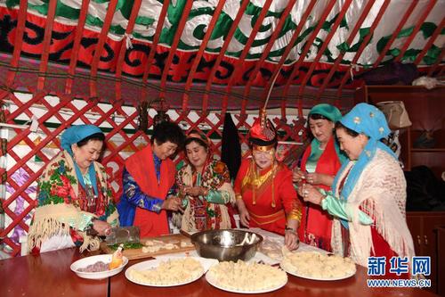 　　2月14日，在托里县哈萨克民宿风情自驾游基地的毡房里，民间社团的团员们在包饺子。5