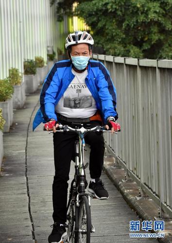 2月23日，香港市民佩戴口罩骑自行车出行。新华社记者 卢炳辉 摄6