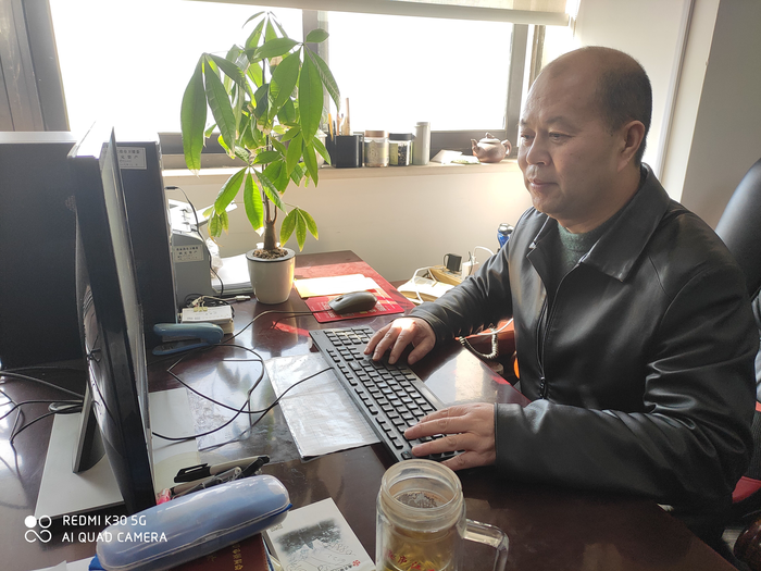 朱长明委员在家里撰写社情民意信息