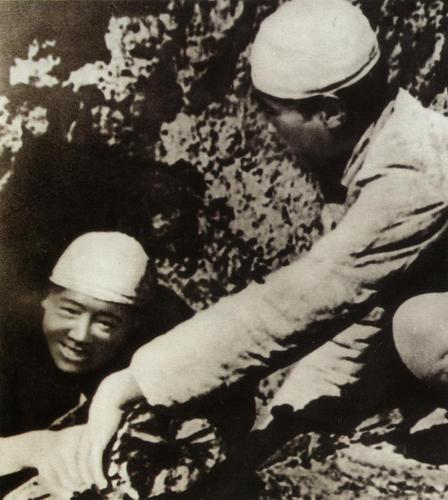 1944年9月，中央警卫战士张思德在烧木炭时牺牲，毛泽东在追悼会上作了《为人民服务》的著名演讲。左为张思德在烧木炭。
